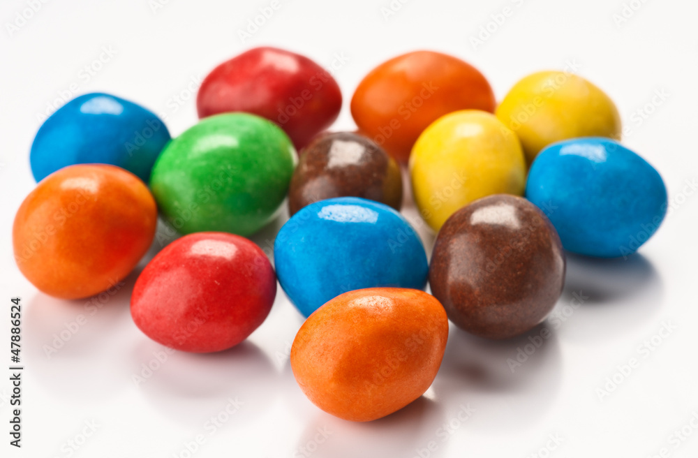 group of colored chocolate balls, on white base group of colored chocolate balls, on white base
