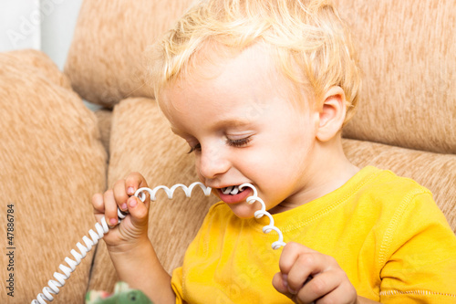 Child biting phone wire