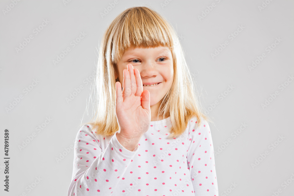 Smiling young girl showing hand signal Smiling young girl showing hand signal