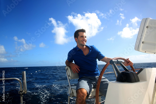 Smiling young sailor navigating in Caribbean sea