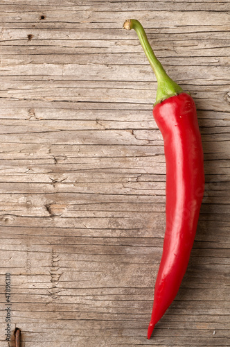 Red hot chillies wooden table background