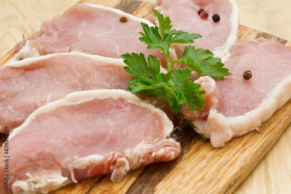Fresh raw meat on wooden background with pepper Fresh raw meat on wooden background with pepper