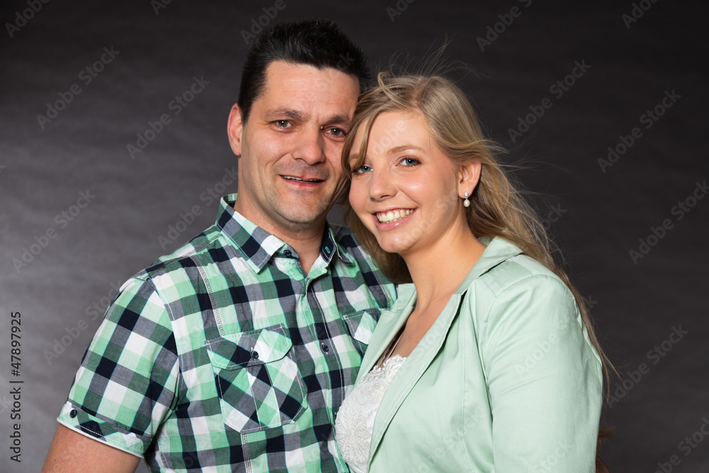 Couple in love. Studio shot against black. Couple in love. Studio shot against black.