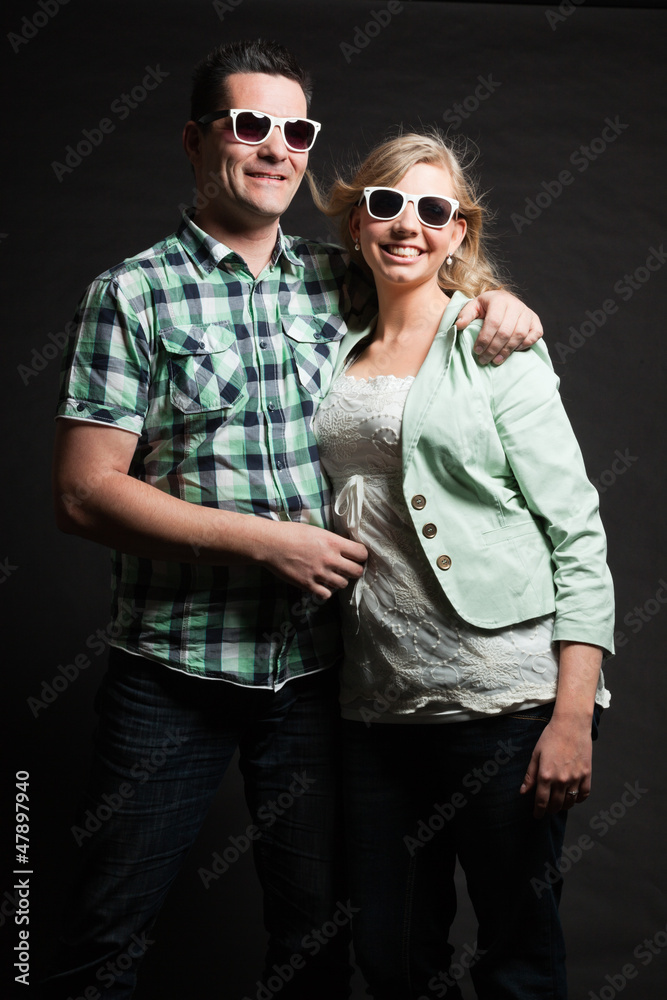 Couple in love. Studio shot against black. Couple in love. Studio shot against black.