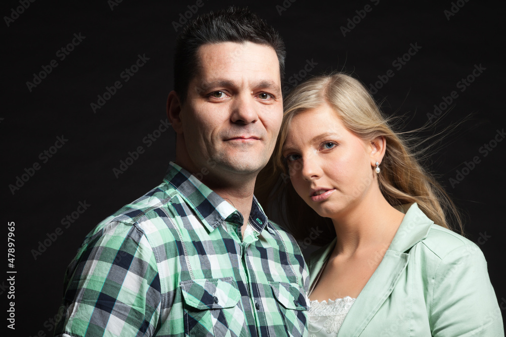 Couple in love. Studio shot against black. Couple in love. Studio shot against black.