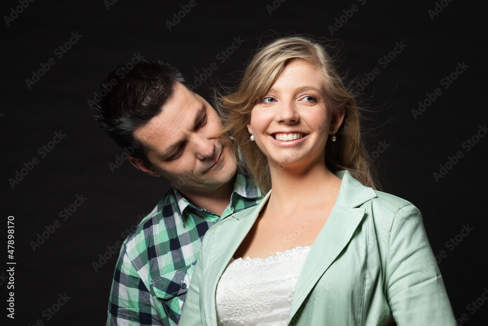 Couple in love. Studio shot against black. Couple in love. Studio shot against black.