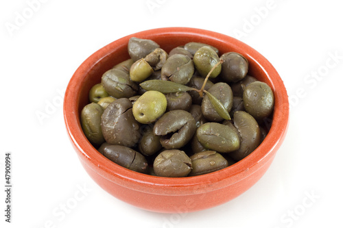 olives in the dish on the white background
