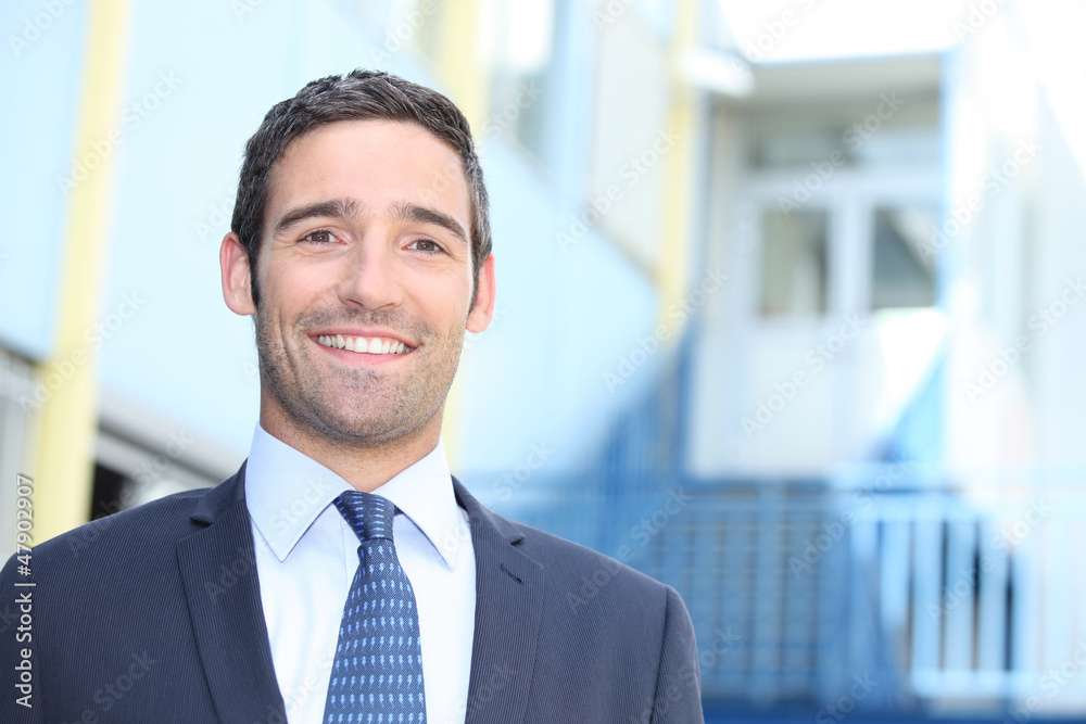 Businessman standing outside a building Businessman standing outside a building