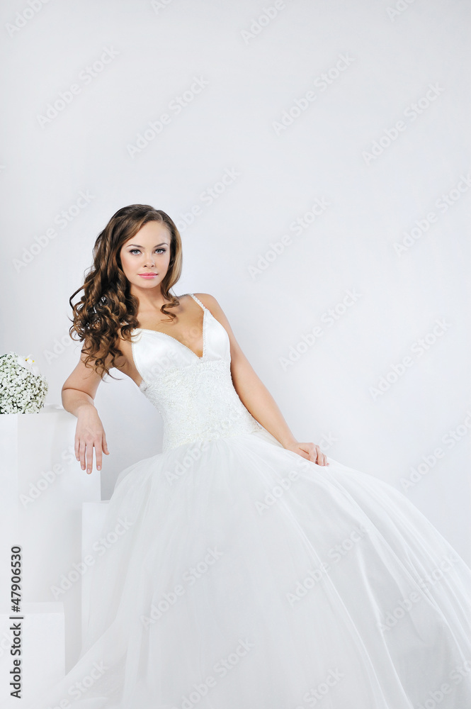 Beautiful smiling girl in a white wedding dress Beautiful smiling girl in a white wedding dress