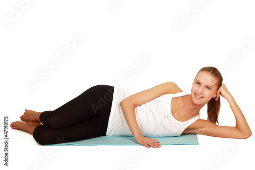 A sportive young woman lying on the floor