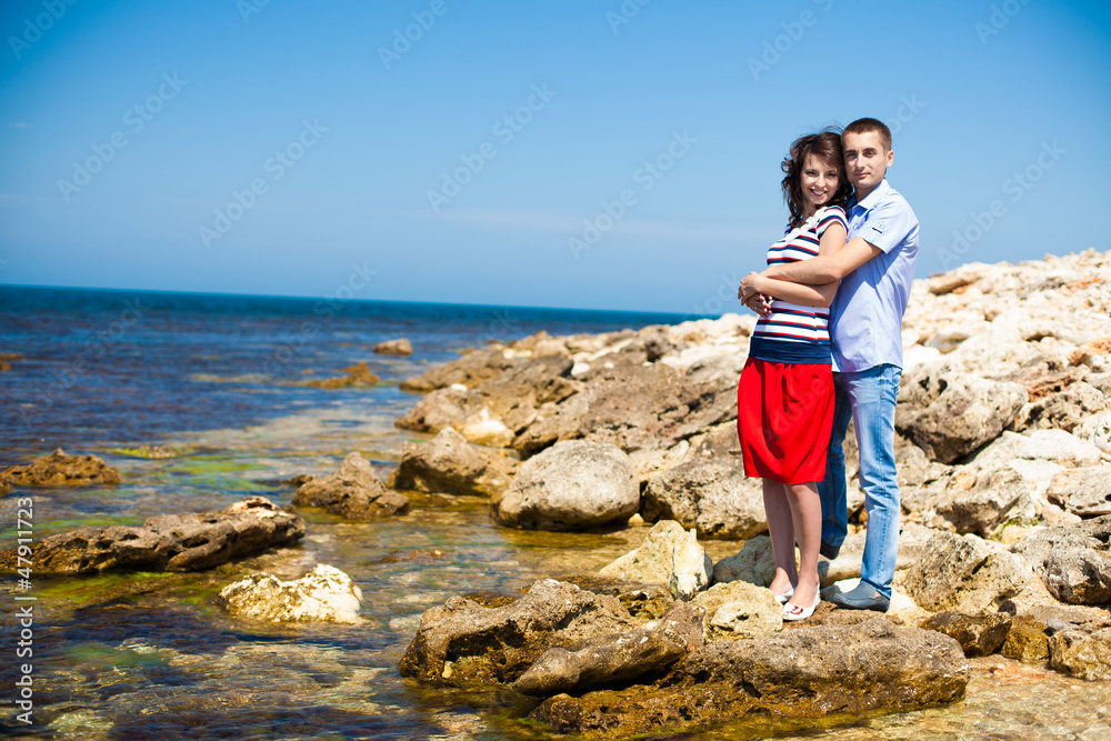 Couple in love on the beach enjoying their vacations