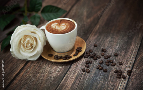 Hot coffee and beautiful white rose