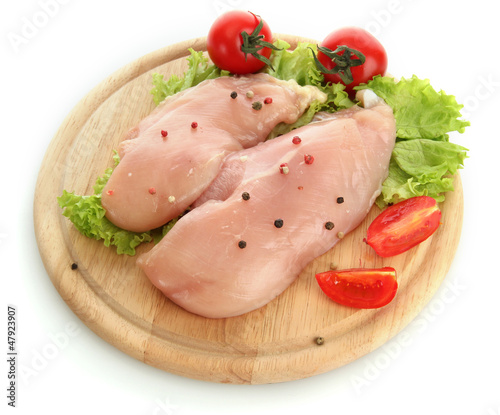 raw chicken meat on cutting board, isolated on white