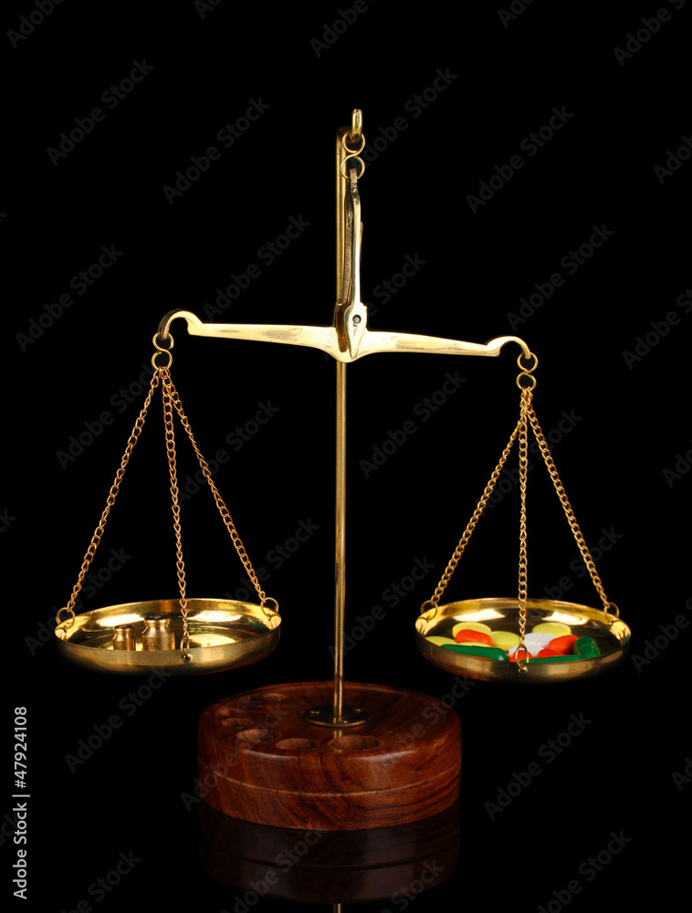 Classic scales with color pills isolated on black Classic scales with color pills isolated on black