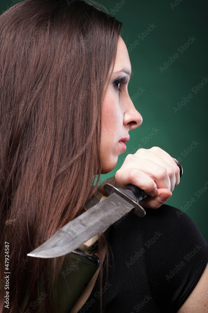 Sexy young woman long hair - gun knife foto de Stock | Adobe Stock