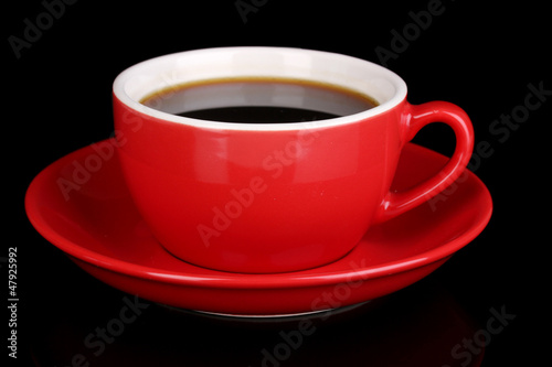 A red cup of strong coffee isolated on black