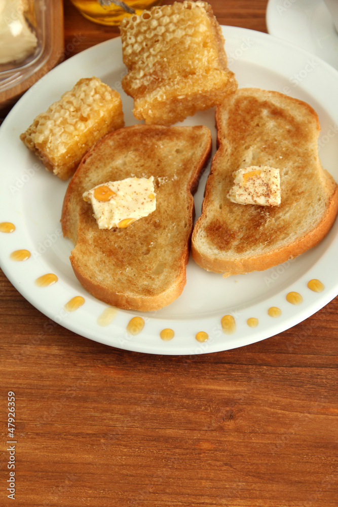 White bread toast with honey and cup of coffee on wooden table White bread toast with honey and cup of coffee on wooden table