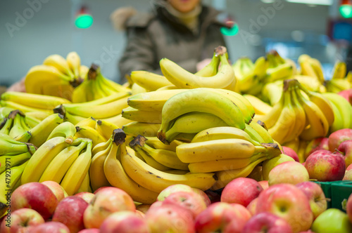 Bunch of bananas and apples in supermarket