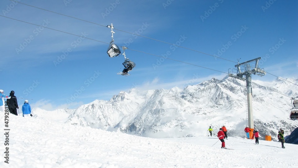 Skier climb down mountain on skis and rise on mountain