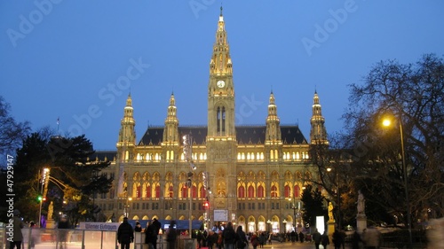 People go for drive on skating rink in front of Rathaus in photo