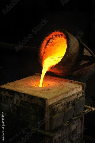 Foundry - molten metal poured from ladle into mould - lost wax