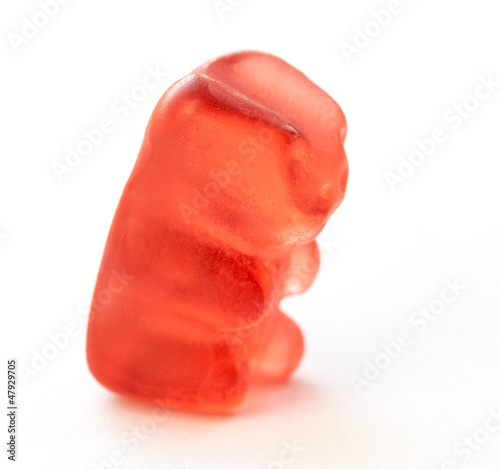 Red jelly bear on white background.