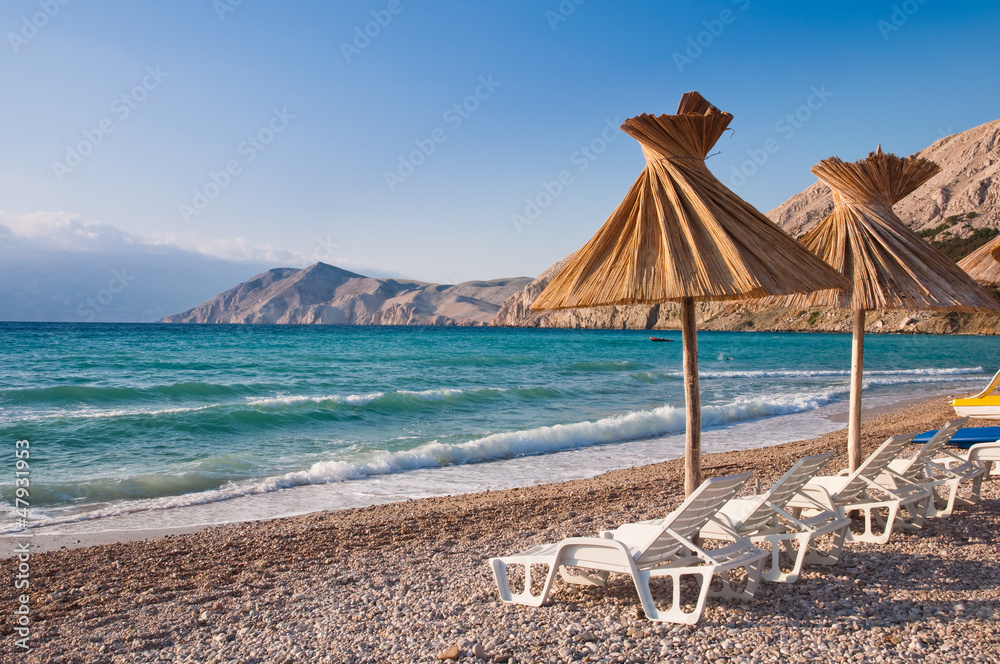 Fototapeta premium Sunshade and deck chair on beach at Baska in Krk - Croatia