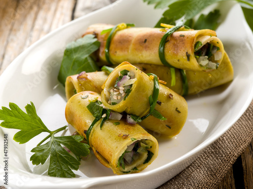 seitan rolled up with parsley and onion, vegetarian food photo