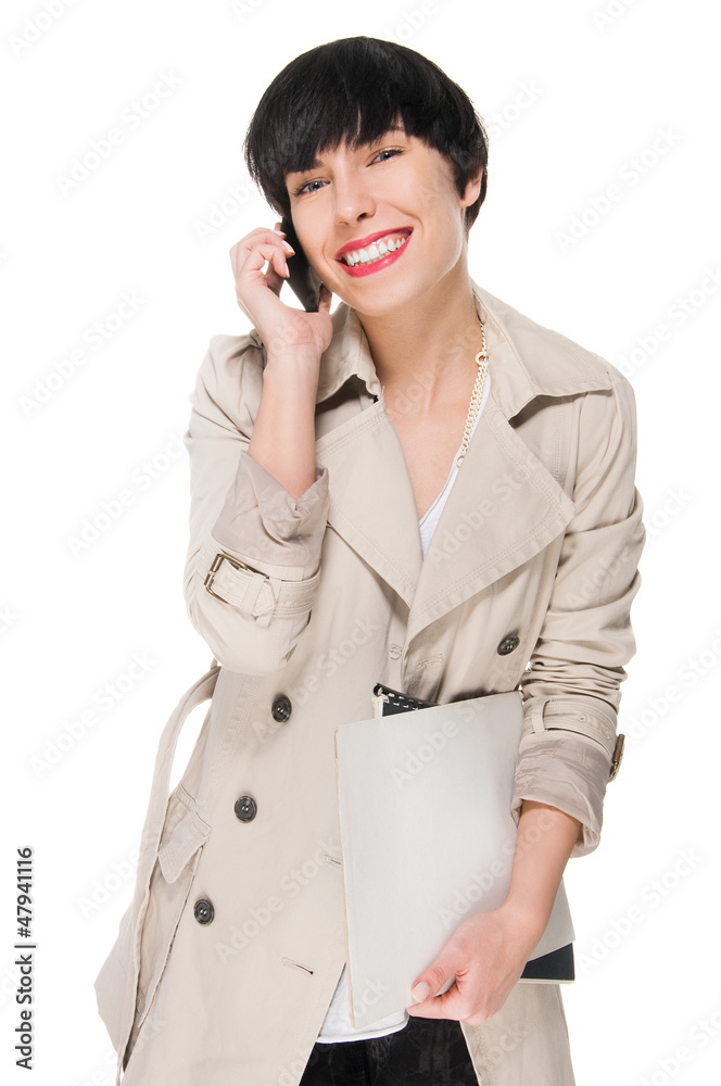 Busy young woman talking on cell phone Busy young woman talking on cell phone
