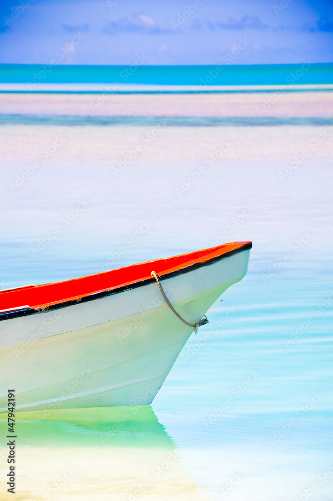 Peaceful calm setting of a boat in a tropical lagoon