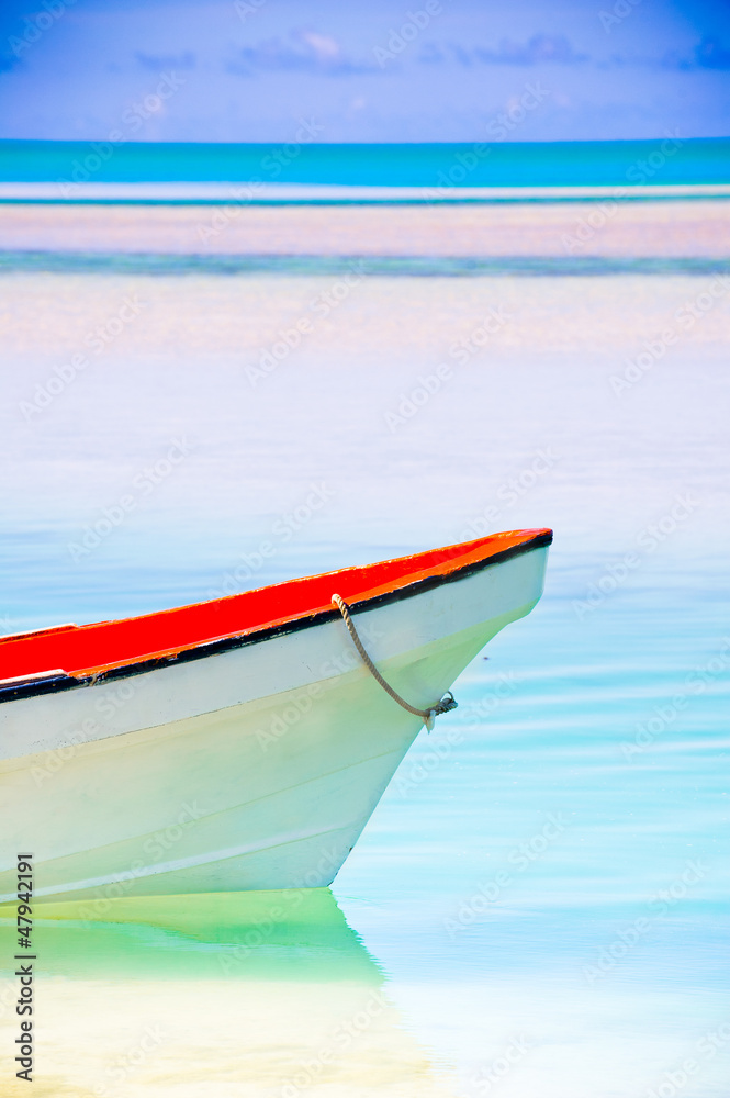 Peaceful calm setting of a boat in a tropical lagoon Peaceful calm setting of a boat in a tropical lagoon