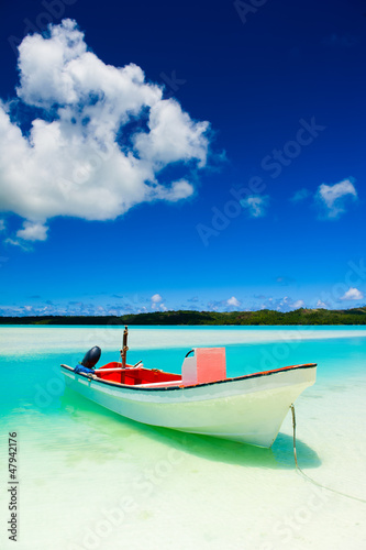 Peaceful calm setting of a boat in a tropical lagoon © Ant Clausen