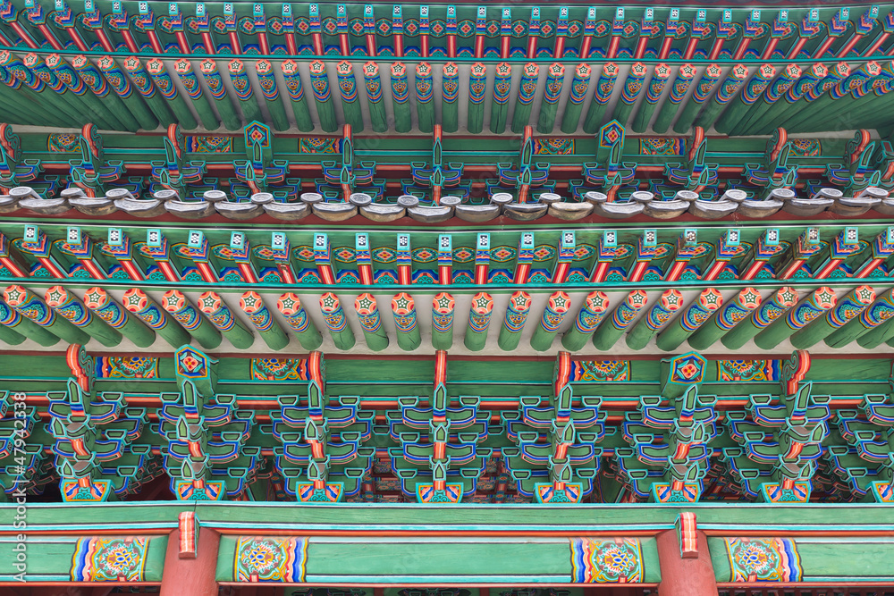 Naklejka premium Decorated woodwork on the roof. Changdeokgung Palace. Seoul