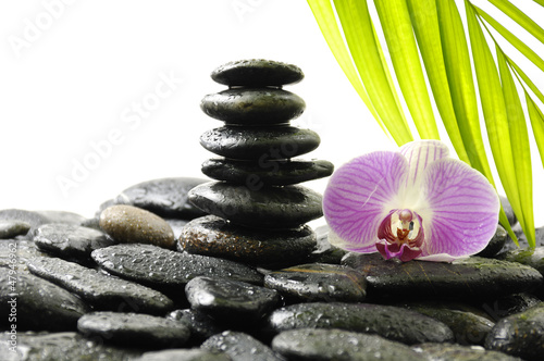 Spa Still life with tower stone on pebble and palm leaf