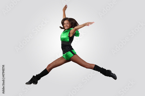 Young female dancer against white background