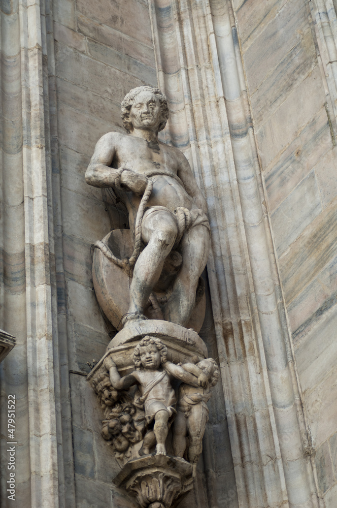 Statue of man  wall of duomo Cathedral in milano