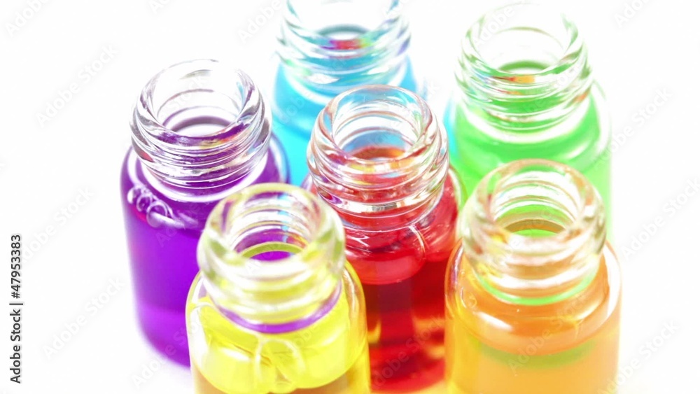 Six transparent open bottles spins with color oil Six transparent open bottles spins with color oil