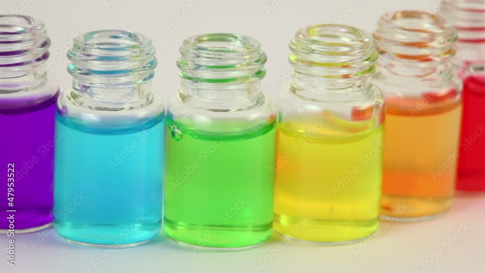 bottles stand in arc row and moves with color oil