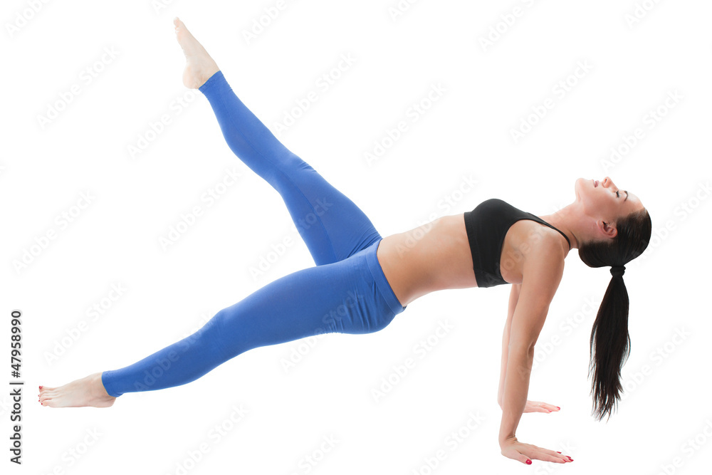 Sexy young yoga woman doing yogic exercise on isolated
