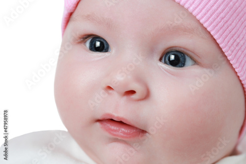 A cute newborn little baby girl with blue eyes isolated