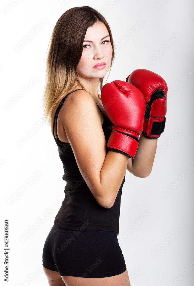 Attractive young woman wearing red boxing gloves Attractive young woman wearing red boxing gloves