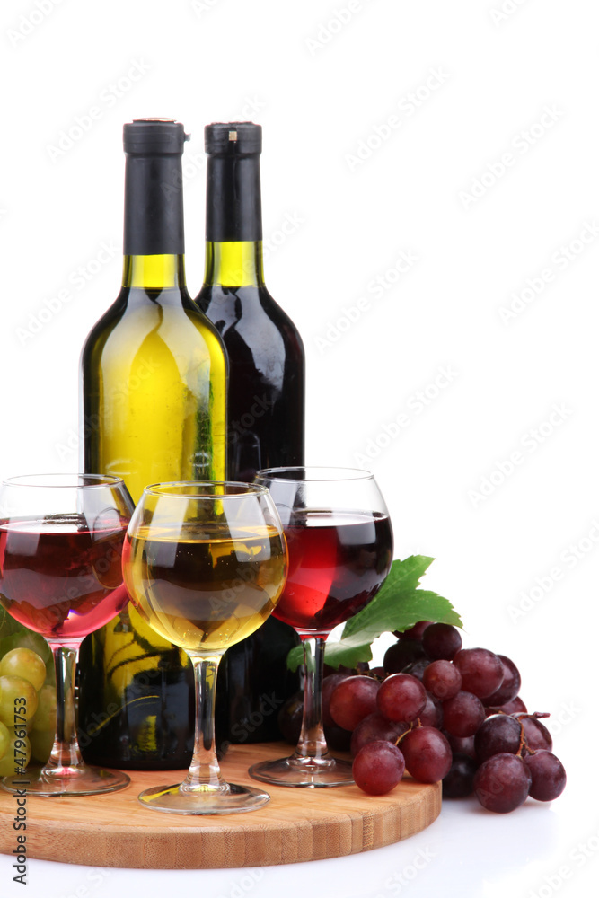 bottles and glasses of wine and assortment of grapes, isolated