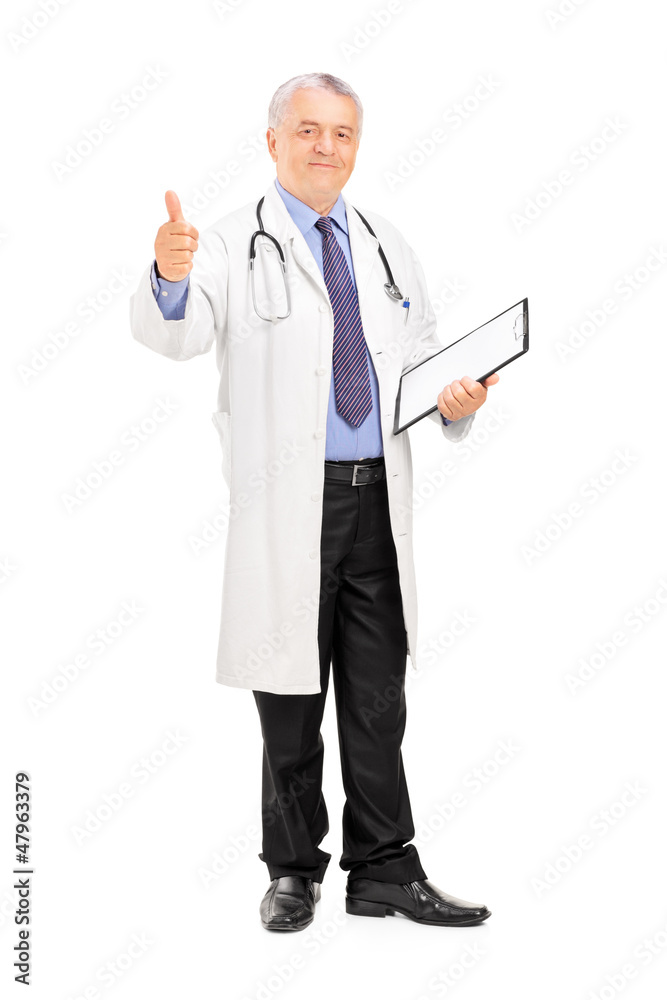 Full length portrait of a male doctor standing and giving a thum Full length portrait of a male doctor standing and giving a thum