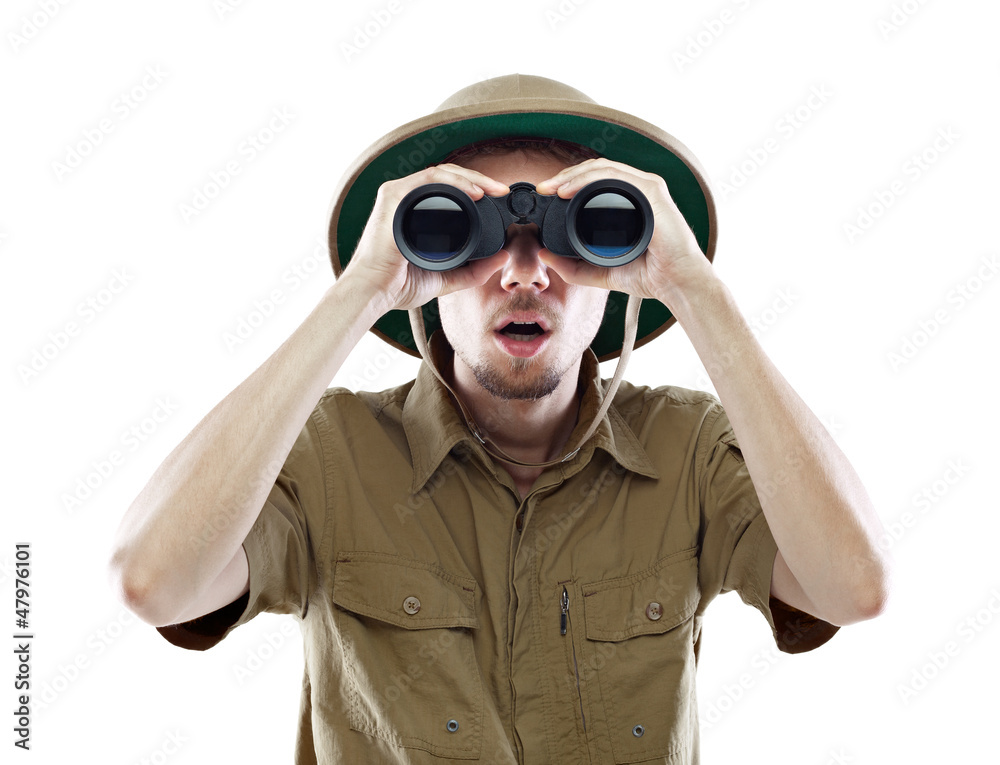 Surprised explorer looking through binoculars