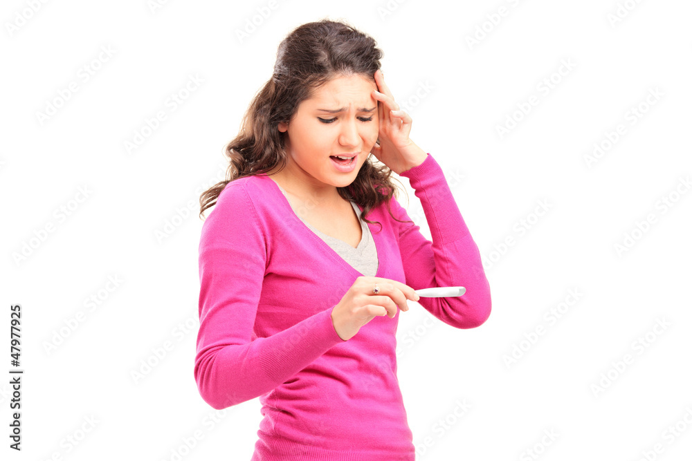 Worried young female checking pregnancy test Worried young female checking pregnancy test