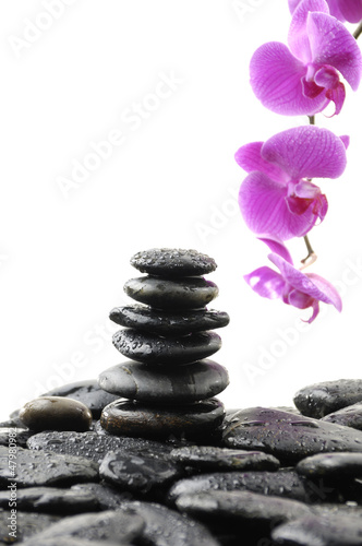 Zen abstract of Stack stones in balance with pink orchid