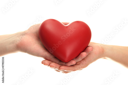 Red heart in woman and man hands  isolated on white
