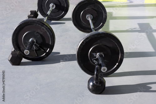 Kettlebells at crossfit gym with lifting bar weights