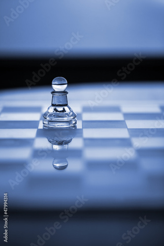 Chess Pawn on Chessboard With Reflection. photo