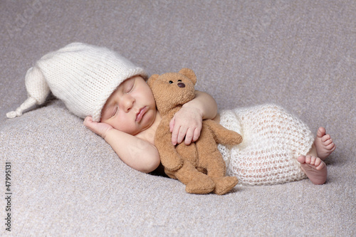 sleeping baby with teddy bear